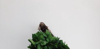 person holding green vegetables