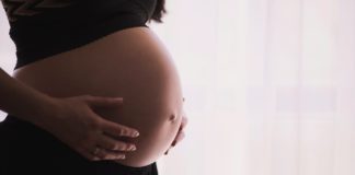 pregnant woman holding tummy